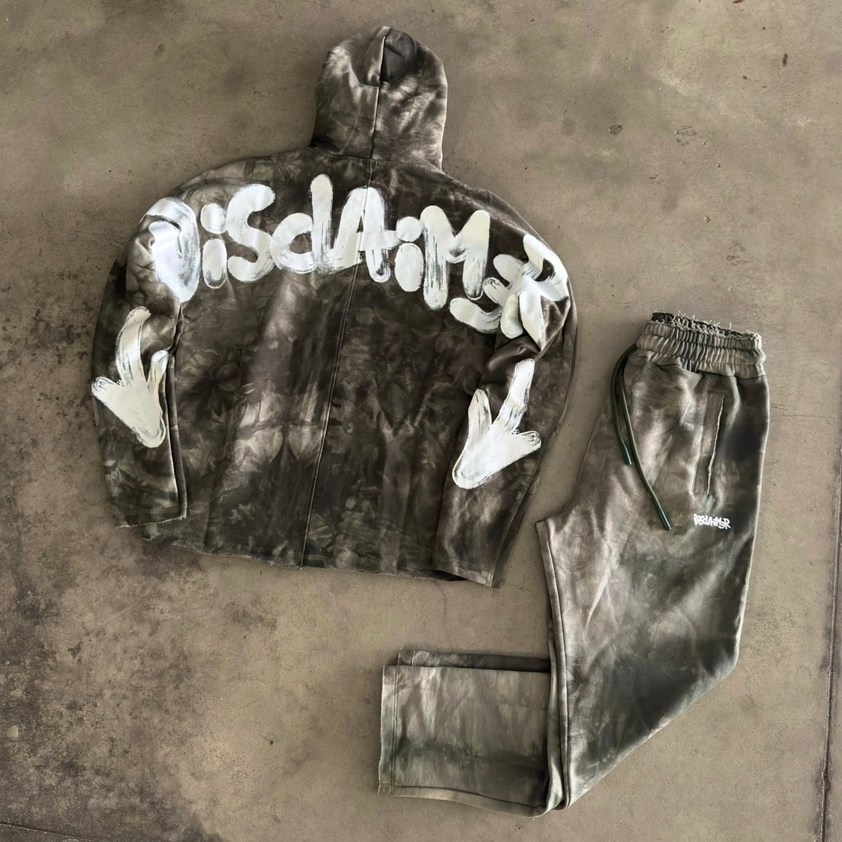 Tuta Disclaimer con Cappuccio Tie-Dye Verde Militare 2026