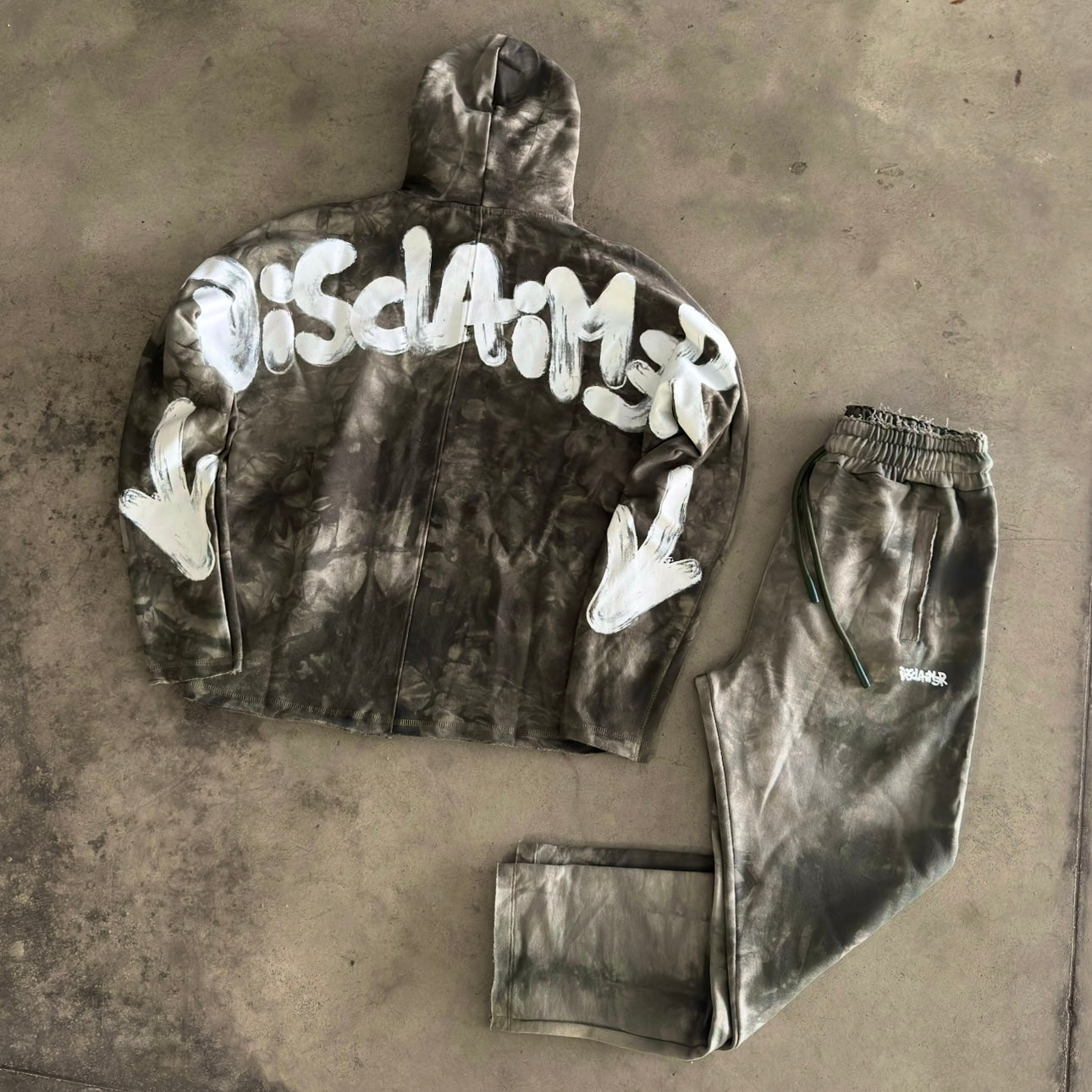 Tuta Disclaimer con Cappuccio Tie-Dye Verde Militare 2026